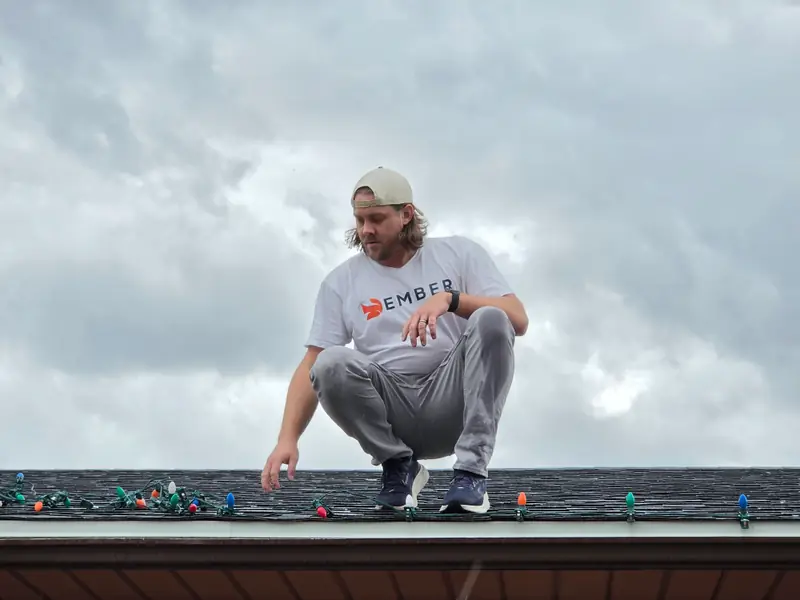 Christmas light installation in Salt Lake City — Ember installer setting C9 bulbs along a roofline